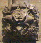 carving of a mouse hidden in leaves